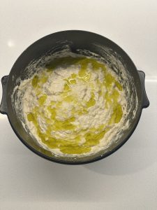 Adding oil to the foccacia dough