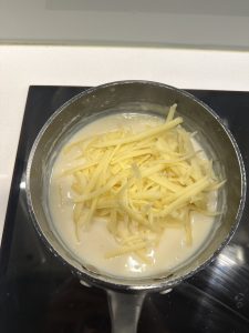 adding cheese to bechamel sauce