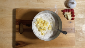 Adding-cold-butter-to-flour.png