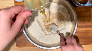 Combine-flour-and-salt-in-a-large-bowl.-Add-warm-water-the-bloomed-yeast-with-sugar-and-50ml-warm-water-and-the-oil.png