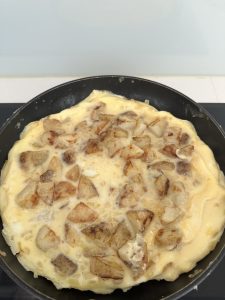 Cooking the tortilla slowly until eggs are set on the bottom