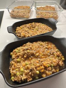 adding the vegan meat sauce to oven proof dishes