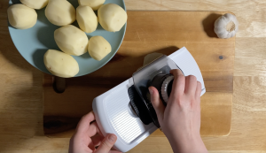 slicing potatoes using a mandoline