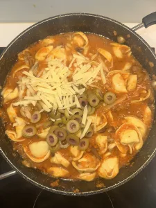 stirring in the olives and cheese